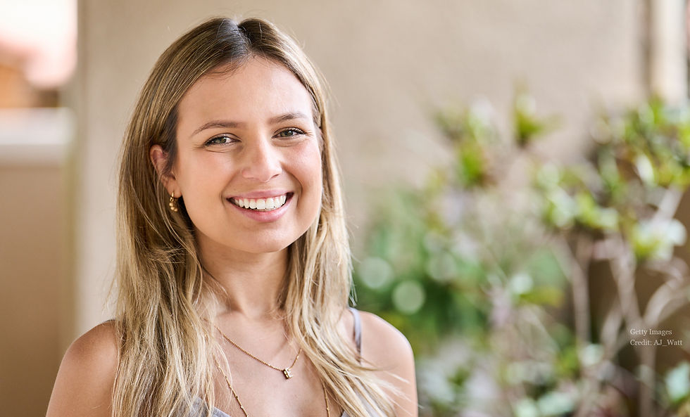A woman in a turtle neck sweater smiling at the camera (model)