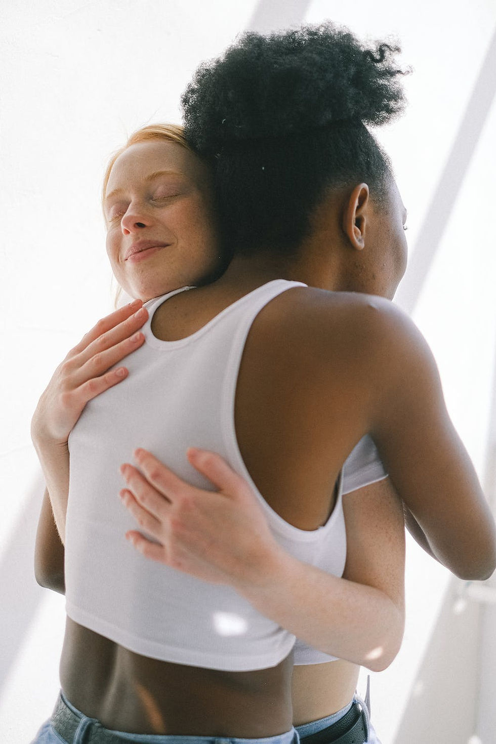 Two woman embrace