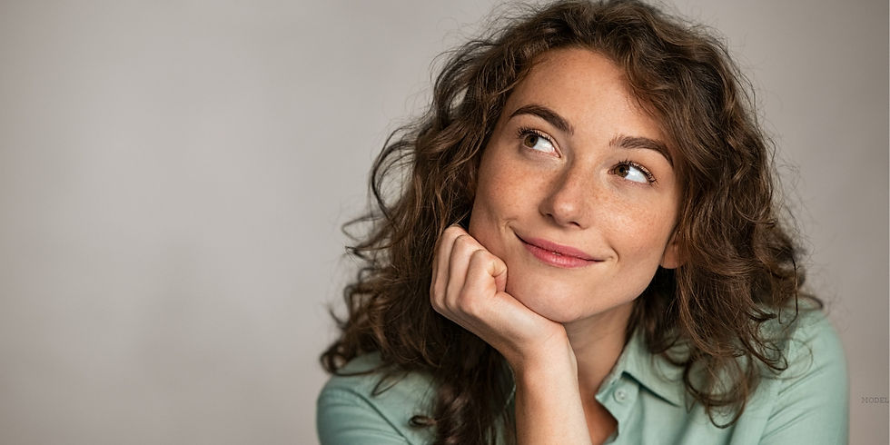 Woman with curly hair looking up at the camera (model)