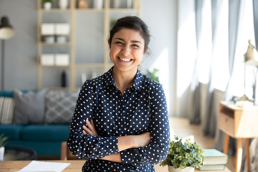 A woman smiling with arms crossed