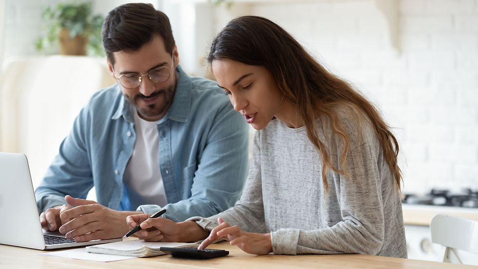 young couple looking at calculator