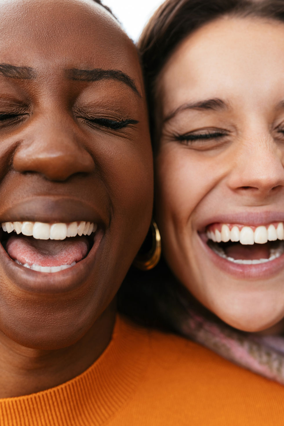 close up of two women smiling next to each other