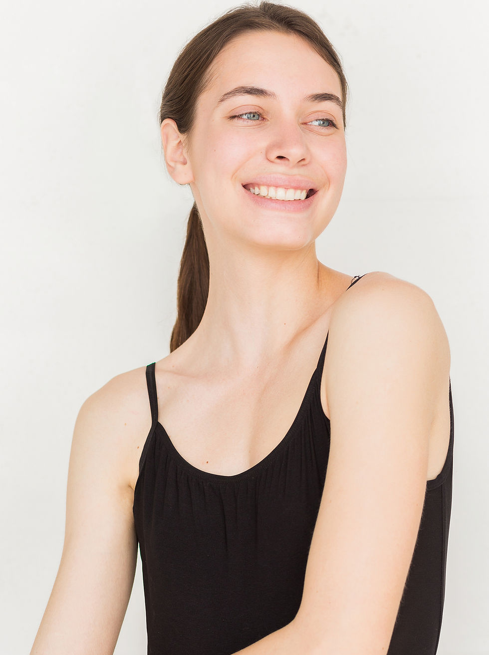 young woman smiling in black tank top