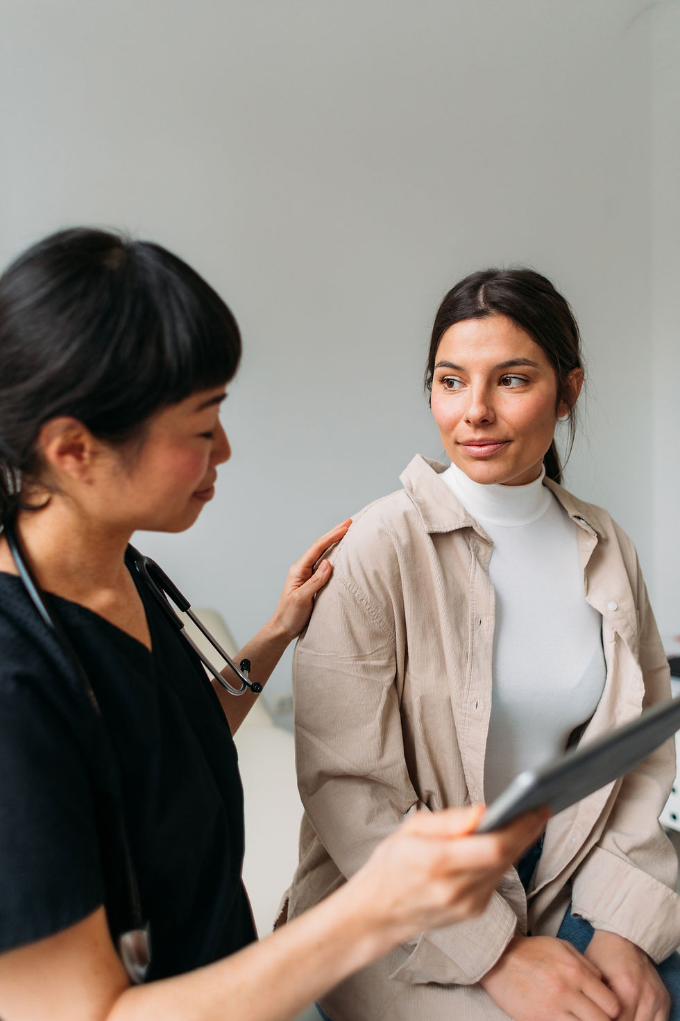 medical professional touching patient's shoulder